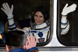 European Space Agency's Italian astronaut Samantha Cristoforetti waves from a bus after her space suit was tested at the Russian-leased Baikonur cosmodrome, prior to blasting off to the International Space Station (ISS) late on November 23, 2014. The international crew is scheduled to blast off to the ISS from Baikonur early on November 24. AFP PHOTO/KIRILL KUDRYAVTSEV