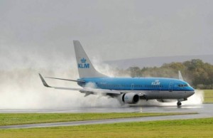 A KLM plane landing at Manchester Airport on the drenched runway in blustery conditions during Hurricane Gonzalo as the North West is hit by the tropical storm.