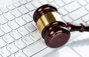 Close up of wooden gavel at the computer keyboard